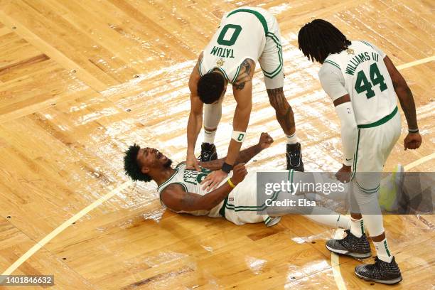 Marcus Smart of the Boston Celtics reacts to a play with teammates Jayson Tatum and Robert Williams III of the Boston Celtics in the fourth quarter...