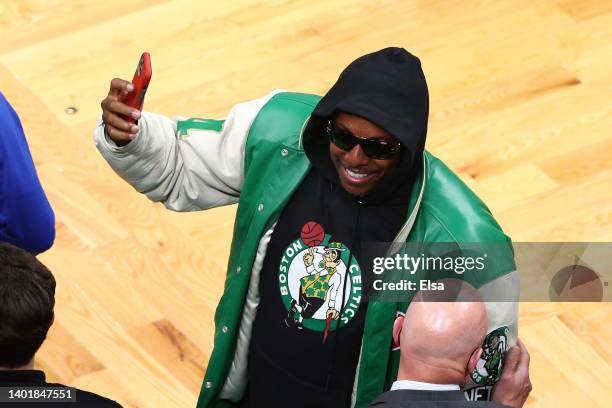 Former Boston Celtics player Paul Pierce celebrates on the sidelines after the Boston Celtics beat the Golden State Warriors 116-100 after Game Three...