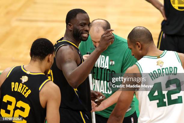Draymond Green of the Golden State Warriors reacts after colliding with Jaylen Brown of the Boston Celtics in the third quarter during Game Three of...