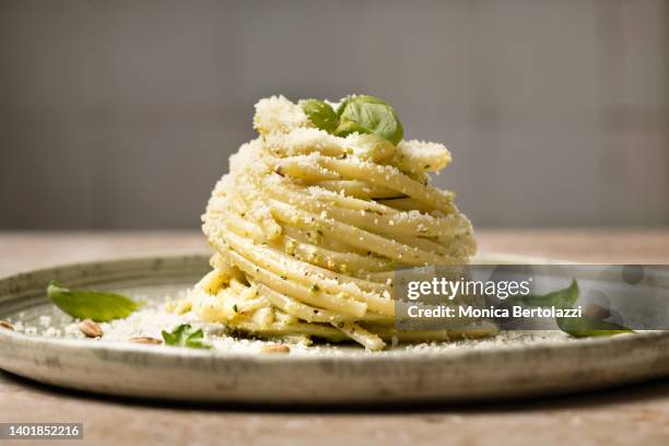 linguine pesto pasta on plate with pine nuts  and basil - pâtes photos et images de collection