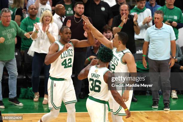 Al Horford of the Boston Celtics reacts after a play with teammates Marcus Smart and Grant Williams in the first quarter against the Golden State...