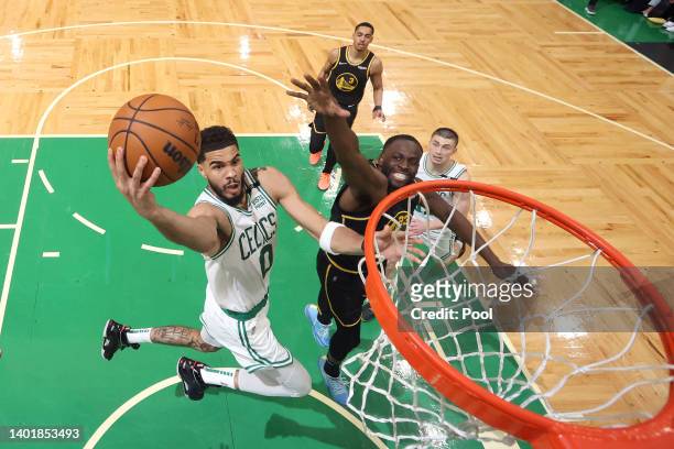 Jayson Tatum of the Boston Celtics drives to the basket against Draymond Green of the Golden State Warriors in the fourth quarter during Game Three...