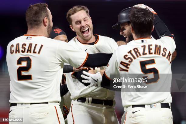 Luis Gonzalez of the San Francisco Giants is congratulated by teammates after he hit a single that resulted in the winning run after a fielding error...