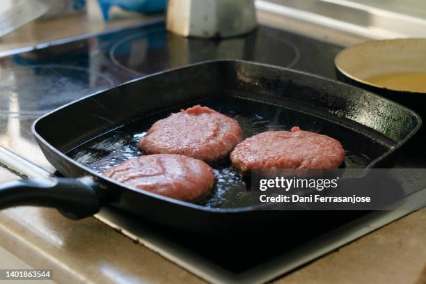 grill with three meat burgers prepared in domestic kitchen. carnivorous food concept. - juicy stock pictures, royalty-free photos & images