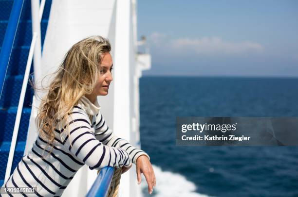 woman on a ferry boat, looking at the sea - fähre stock-fotos und bilder