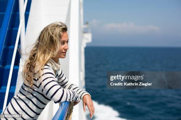 woman on a ferry boat, looking at the sea - ferry ストックフォトと画像
