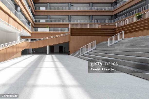 the sun shines on the open corridor of the library - glowing doorway stock pictures, royalty-free photos & images