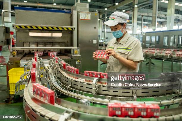 An employee works on the production line of dairy products at a factory of Want Want China Holdings Limited on June 8, 2022 in Chengdu, Sichuan...