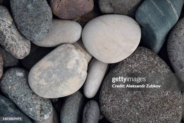 abstract background with coastal pebbles. round large sea stones on the shore of the sea, lake or river. the concept of travel and tourism. - 石 ストックフォトと画像