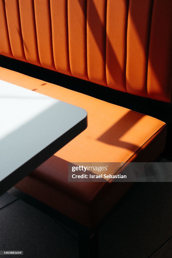 Close-up view of the seat and table in a restaurant.