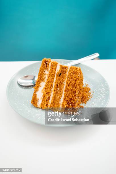 close up view of a slice of chocolate and cream cake on a black table and blue background. - gateaux bildbanksfoton och bilder