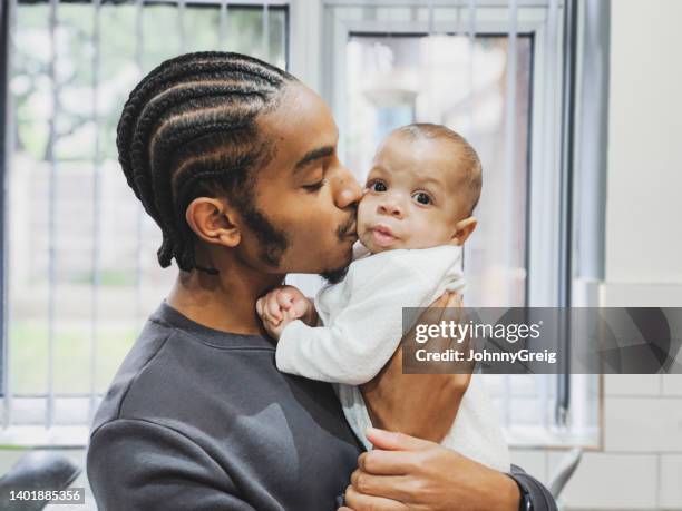 tender young father kissing his baby daughter - taken on mobile device stock pictures, royalty-free photos & images