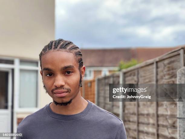 headshot portrait of young black man - cornrows stock pictures, royalty-free photos & images