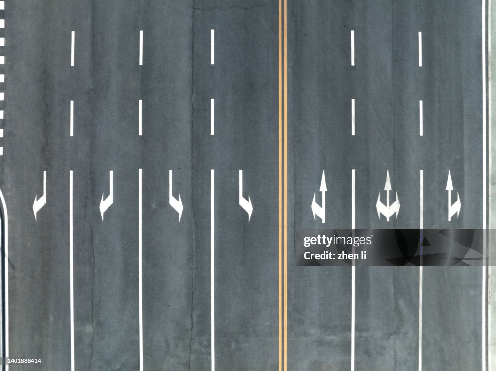 High Angle View Of Arrow Symbol On Road