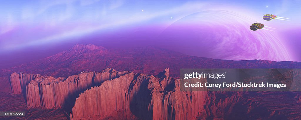 Two spacecraft fly over a mountain range coming in for a landing on another world.