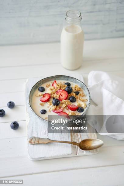 granola with yogurt and strawberries - white chopping board stock pictures, royalty-free photos & images