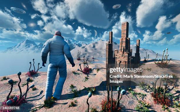an astronaut making contact with an alien being on a planet whose atmosphere and environment is similar to that of earth. - astronaut walking stock illustrations