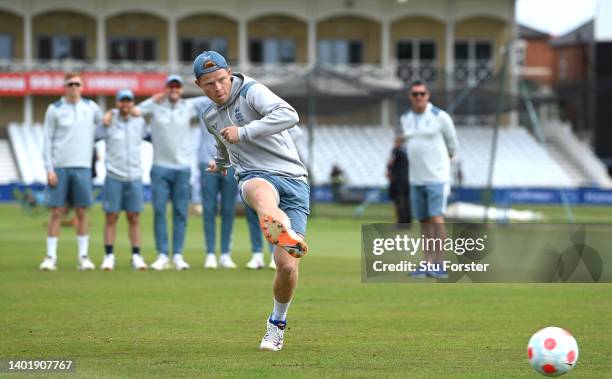 England batsman Ollie Pope scores a penalty during a football penalty shoot out as his team mates from the South team look on during nets ahead of...