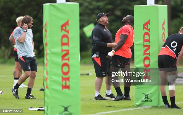 England coach, Matthew Proudfoot assesses Biyi Alo of England during an England rugby training session held at The Lensbury Hotel on June 09, 2022 in...