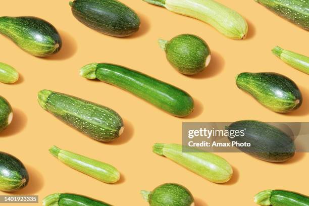 green zucchini vegetable pattern still life - courgette stock pictures, royalty-free photos & images