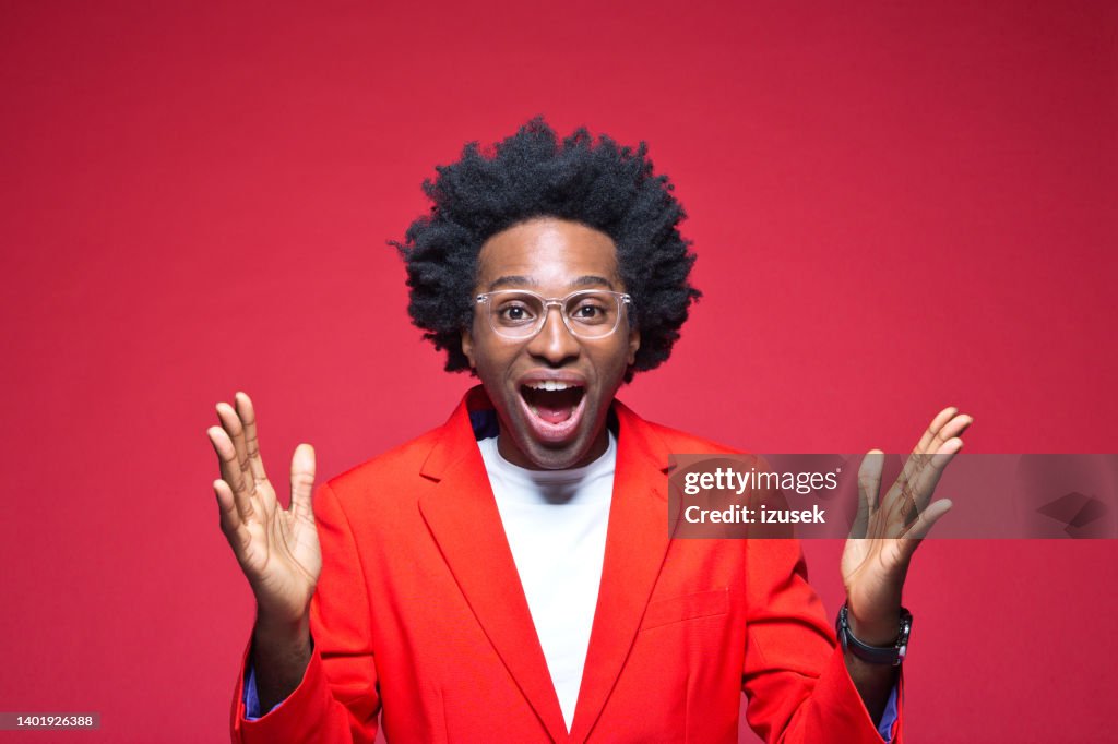 Happy businessman in red blazer gesturing