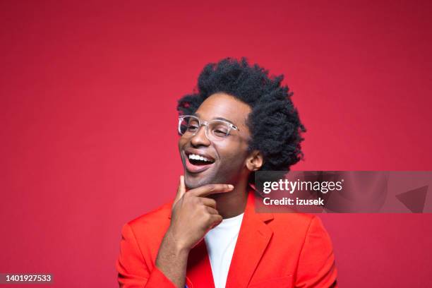 happy businessman with hand on chin - man in red blazer stock pictures, royalty-free photos & images