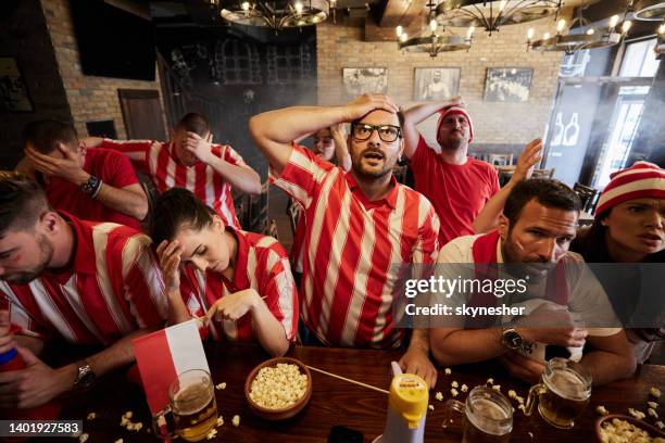 oh no, they've lost the game! - red sports jersey stock pictures, royalty-free photos & images