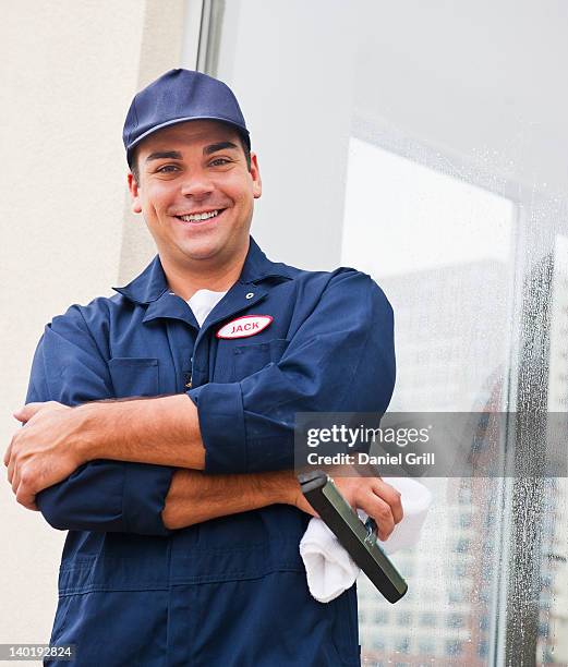 usa, new jersey, jersey city, man cleaning window - window cleaner stock-fotos und bilder