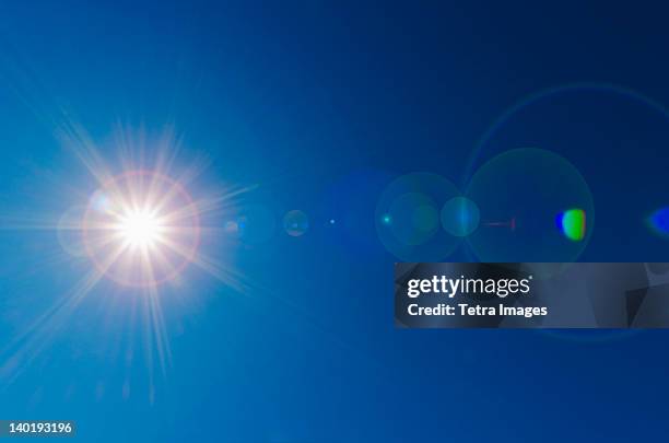 blue sky with solar flare - sunlight flare stock pictures, royalty-free photos & images