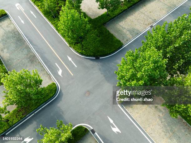 aerial view of crossroad - road intersection stock-fotos und bilder