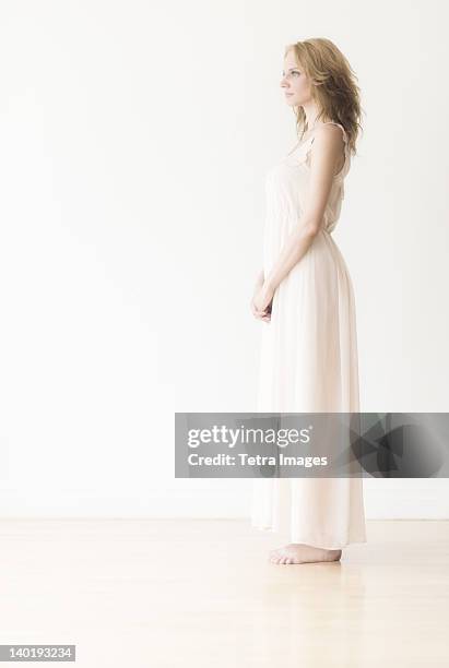 woman against white background, studio shot - negligée stock-fotos und bilder