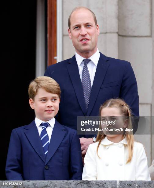 Prince George of Cambridge, Prince William, Duke of Cambridge and Princess Charlotte of Cambridge stand on the balcony of Buckingham Palace following...