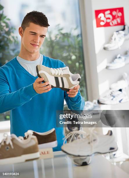 usa, new jersey, jersey city, teenage boy (16-17) buying shoes - teenager boy shopping stock-fotos und bilder