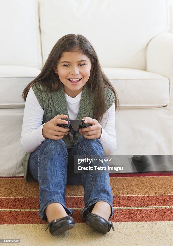 USA, New Jersey, Jersey City, Girl (10-11) playing video games