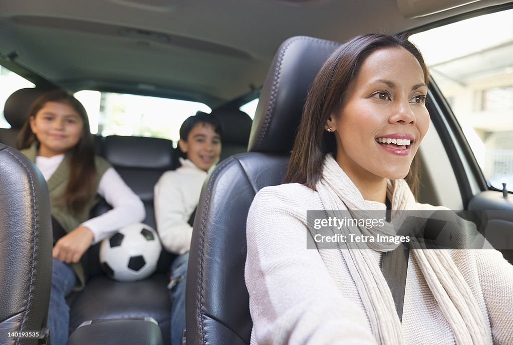 USA, New Jersey, Jersey City, Mother with son (12-13) and daughter (10-11) in car