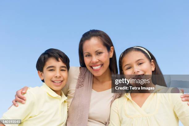 usa, new jersey, jersey city, portrait of mother with son (12-13) and daughter (10-11) - jersey city stock pictures, royalty-free photos & images