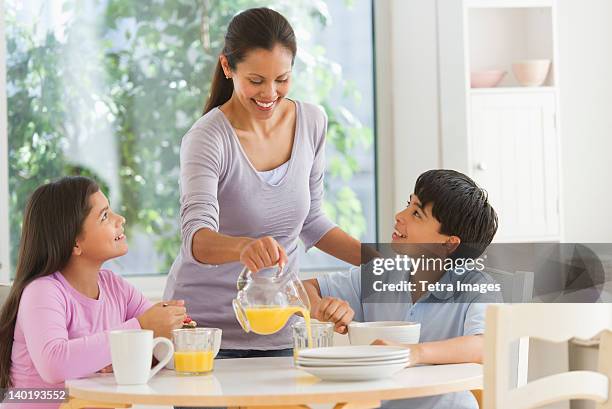 usa, new jersey, jersey city, mother with son (12-13) and daughter (10-11) having breakfast - jersey city stock pictures, royalty-free photos & images