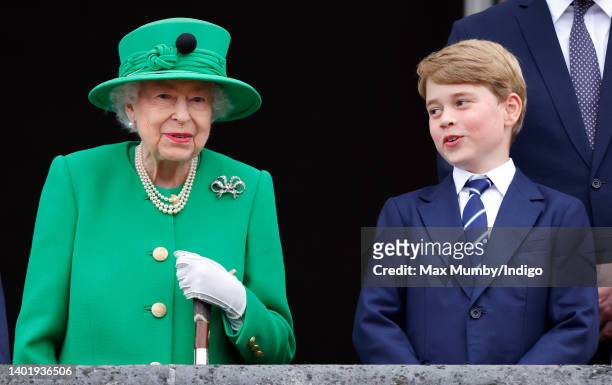 Queen Elizabeth II and Prince George of Cambridge stand on the balcony of Buckingham Palace following the Platinum Pageant on June 5, 2022 in London,...
