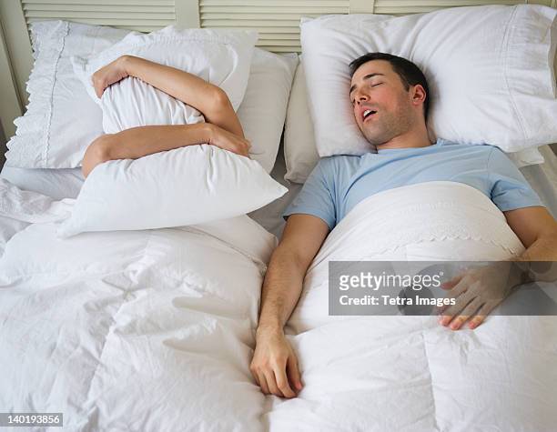 usa, new jersey, jersey city, couple in bed, man snoring - couple sleeping fotografías e imágenes de stock