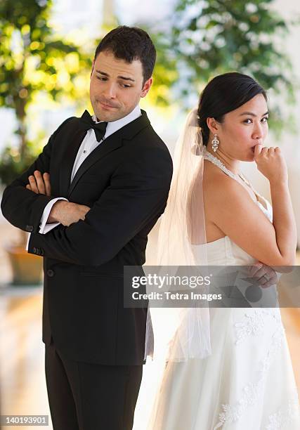 usa, new jersey, jersey city, bride and groom looking nervous standing back to back - nervous bride stock pictures, royalty-free photos & images