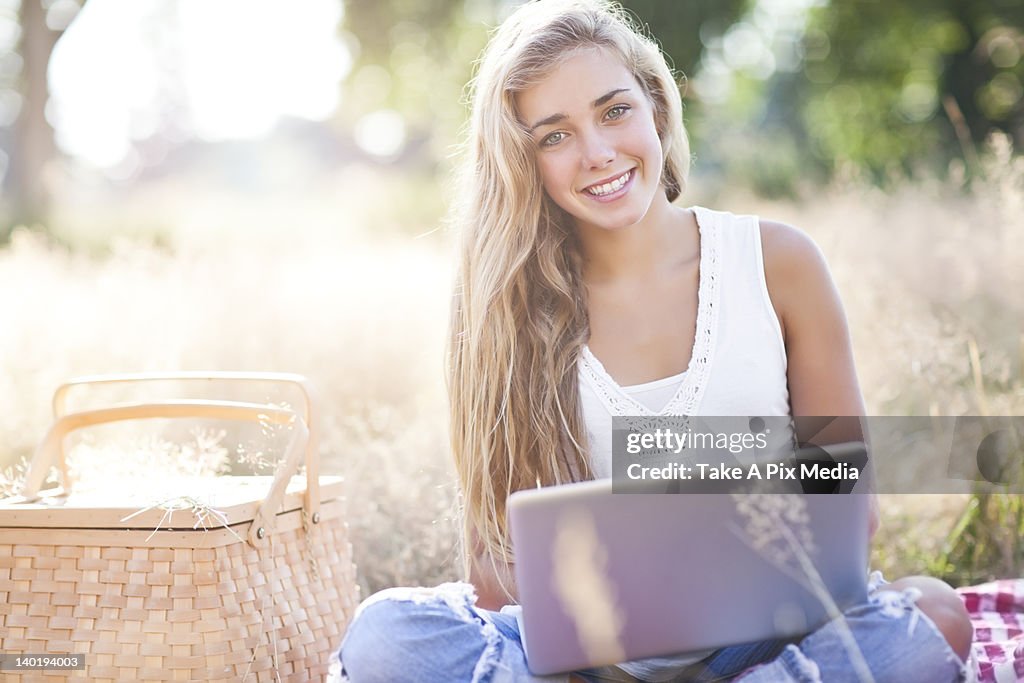 USA, Washington, Seattle, Teenage girl (16-17) posing with laptop outdoors