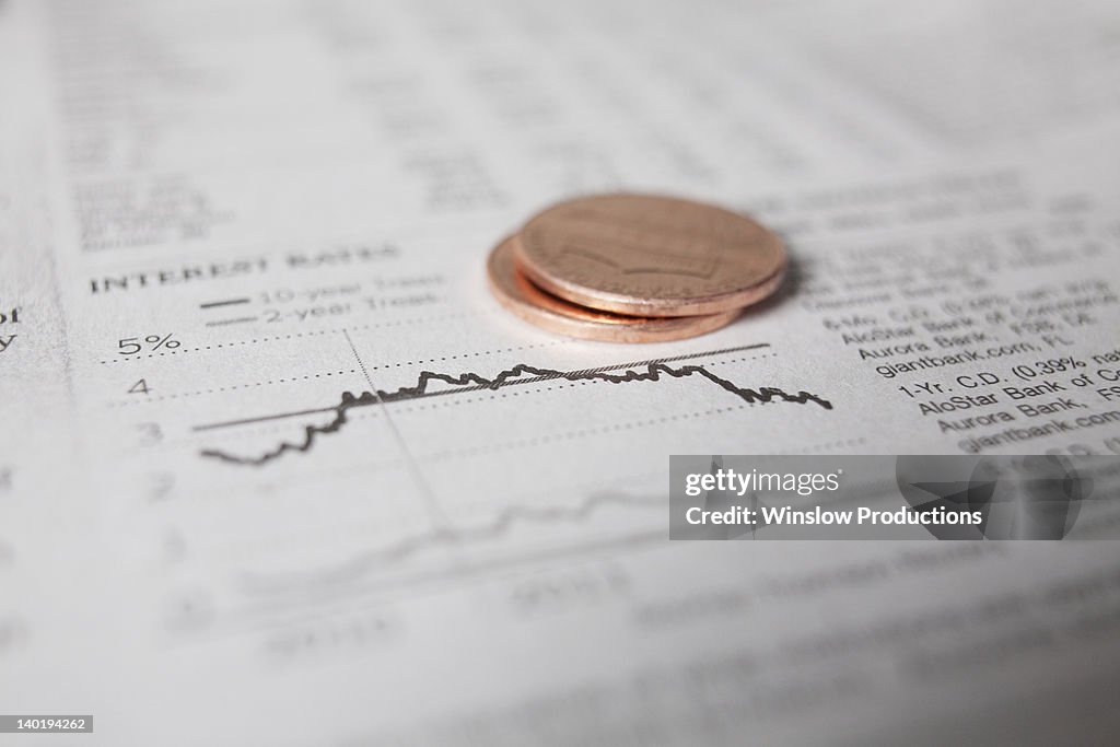 Studio shot of coins on financial newspaper