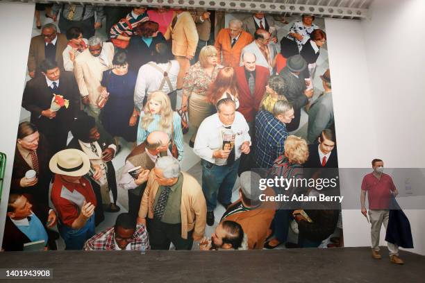 Visitor walks past the work "Crowd " by Alex Prager at a press preview for the 12th Berlin Biennale at Hamburger Bahnhof on June 09, 2022 in Berlin,...