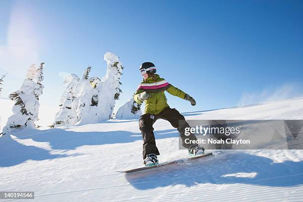 usa, montana, whitefish, snowboarder on slope - woman snowboarding stock pictures, royalty-free photos & images