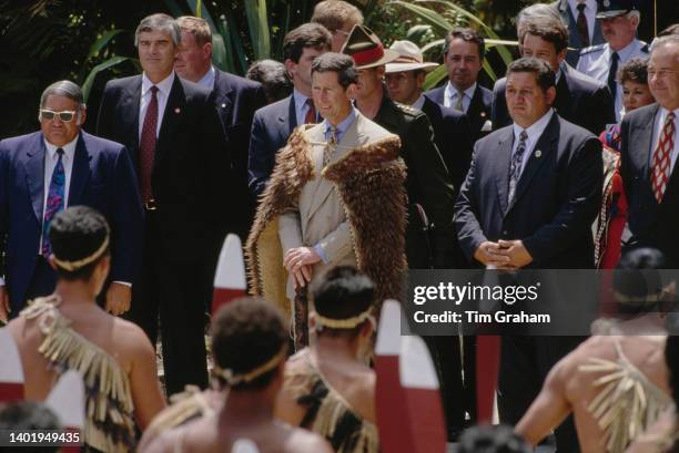 Prince Charles adorned with traditional Maori attire stands poised with a staff to meet the Maori Queen - Queen Te Atairangikaahu at Turangawaewae in...