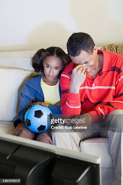 usa, california, los angeles, father and daughter (10-11) watching sports on tv - losing virginity stock pictures, royalty-free photos & images