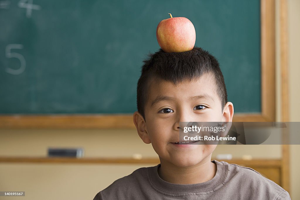 USA, California, Los Angeles, Boy (6-7) with apple on his head