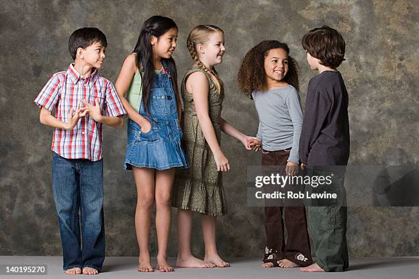 children (6-7, 8-9) playing together, studio shot - kid studio shot stock pictures, royalty-free photos & images