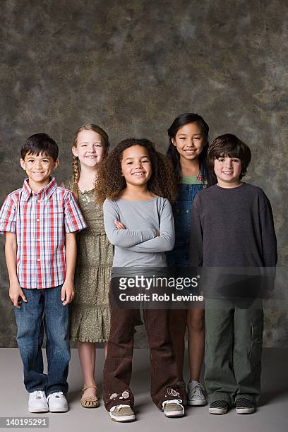 children (6-7, 8-9) posing together, studio shot - children only stock pictures, royalty-free photos & images