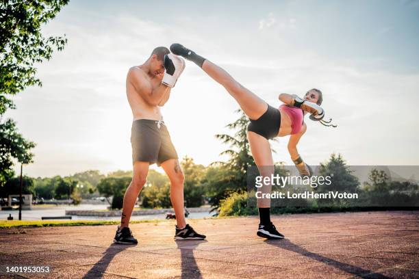 man and a woman practicing kick boxing - an evening dedicated to women of substance imagens e fotografias de stock